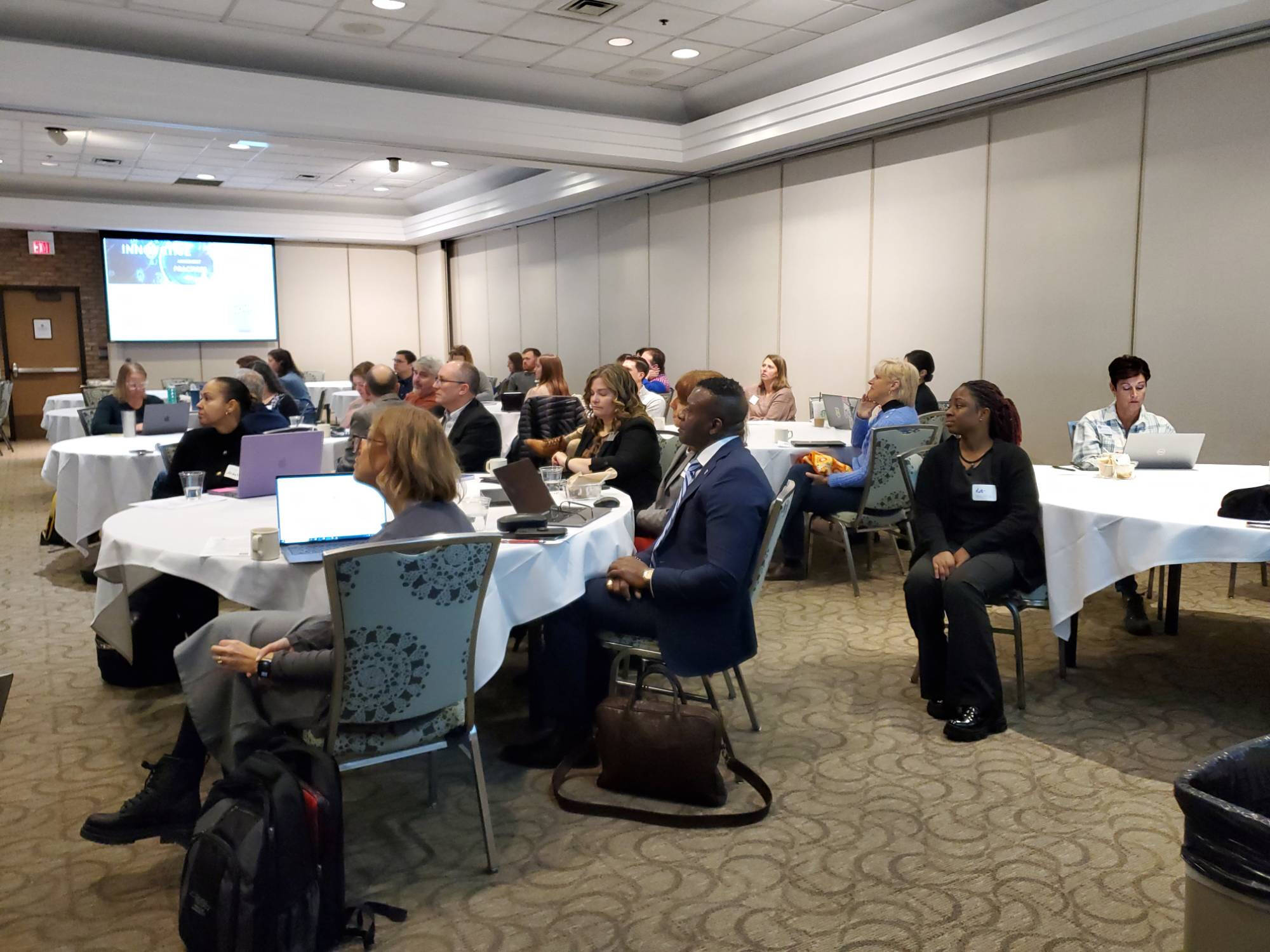 Conference attendees listen and participate in the keynote